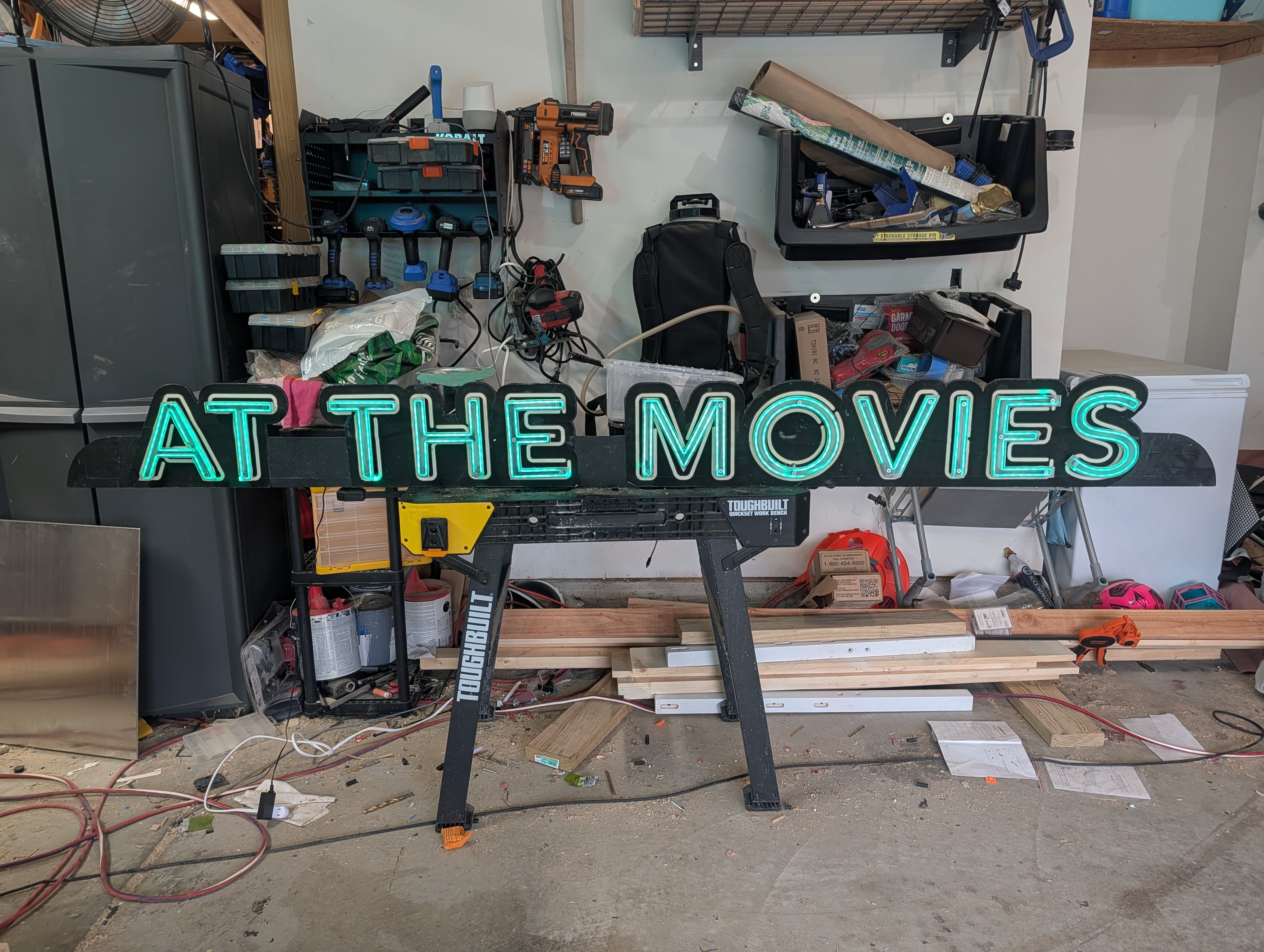 Neon-style LED sign reading At The Movies — over 7 feet wide